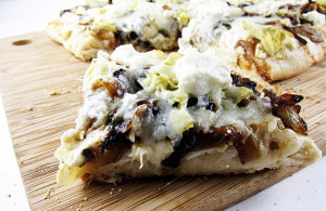 pizza with roasted garlic sauce, caramelized onion, mushrooms and artichokes